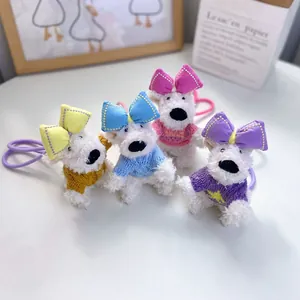 Detail view of cute plush Westie dog keychains with colorful bows and sweaters