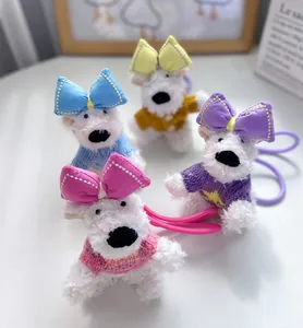 Detailed view of four colorful Westie dog plush keychains with bows and sweaters
