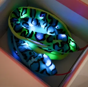 Macro detail of realistic glowing plush snake toys with LED lights inside a gift box