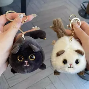 Dos lindos llaveros de gato de peluche con colas móviles en colores negro y crema