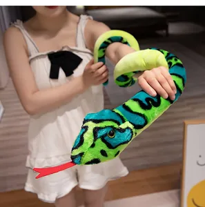 Detailed view of the large green and blue plush snake wrapped around a model's arm