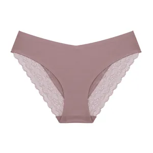 Macro detail of women's seamless lace briefs in dusty pink featuring floral embroidery