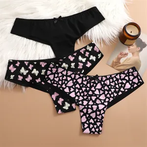 Close-up of sexy mesh thongs with heart and butterfly prints and bow details.