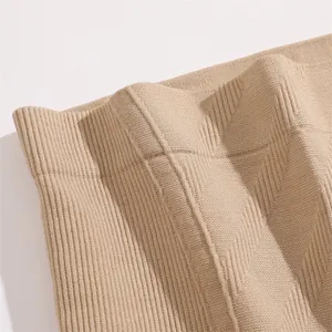 Detailed view of the seamless ribbed waistband and textured fabric on beige shaping panties