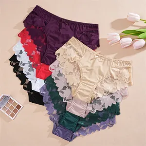 Multi-color lace patchwork low-waist women's panties displayed with floral props