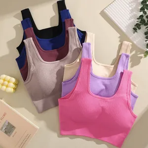 Macro detail showing multiple colorful ribbed sports bras with square neck and chest pads