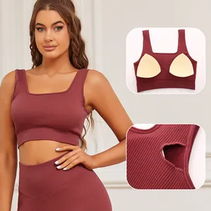 Macro view of burgundy ribbed sports bra showing the removable pad insertion slot detail