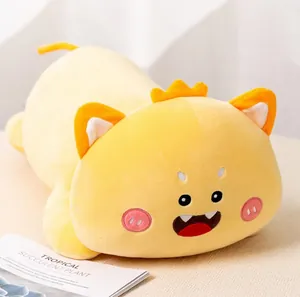 Detailed view of a cute yellow monster plush long pillow with friendly facial features