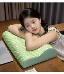 Detail shot of ergonomic green waffle memory foam nap pillow for office desk use