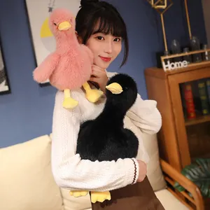 Close-up detail of cute pink and black plush duck dolls made of soft mink velvet fabric