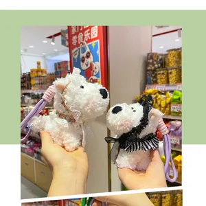 Detailed view of white Westie plush dog keychains with lace and bow accessories