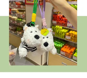 Close-up of fluffy white Westie dog plush keychain charms with colorful braided ropes