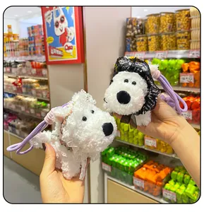 Detail view of two cute Westie plush dog keychains featuring white and black lace veils