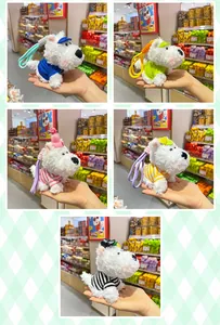 Detail view of colorful Westie plush dog keychains with striped shirts and matching hats.