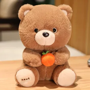 Close-up of a brown plush teddy bear holding an orange persimmon fruit on a wooden table