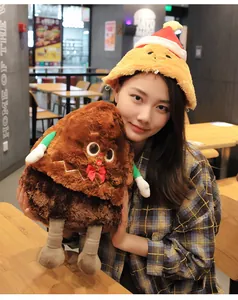 Cute plush gingerbread man toy and festive Christmas hat shown in a lifestyle setting