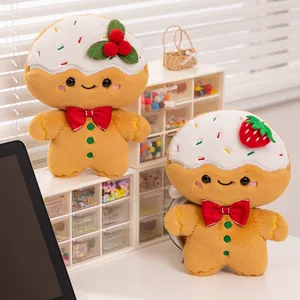 Zwei süße Weihnachts-Lebkuchenmann-Plüschpuppen dekoriert mit weißem Creme-Guss