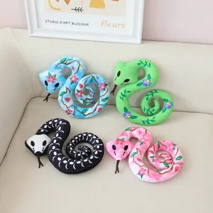 Stylized snake plush toys featuring vibrant floral and skull patterns for Halloween home decor