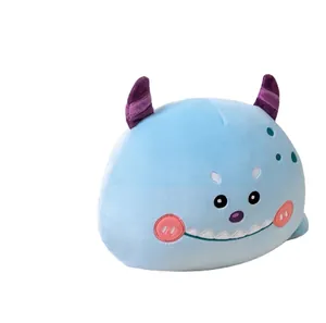 Soft blue monster plush pillow toy with purple horns and cute smiling face design