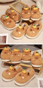 Close-up macro view of Capybara plush slippers with tangerine decor on a wooden stand.