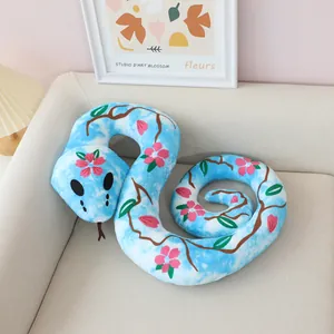 Close-up of blue plush snake toy featuring pink blossom patterns and soft texture
