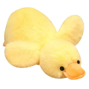 Soft fluffy yellow duck plush toy doll in a lying position for sleeping and hugging