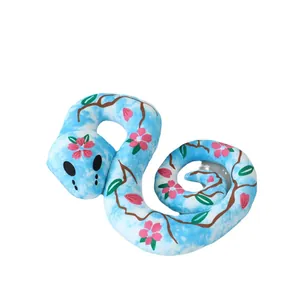 Cute blue snake plush toy decorated with pink cherry blossoms and brown branches