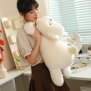 Close-up of a girl holding a soft white plush dog toy in a cozy interior setting