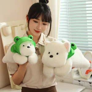 Asian model holding two cute white Westie dog plush toys wearing green frog hats