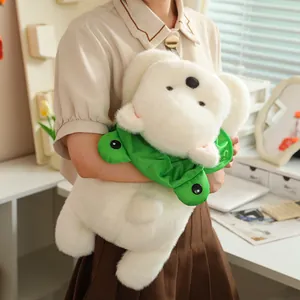 Soft white Westie plush dog held in arms, showcasing fuzzy texture and cute frog collar.