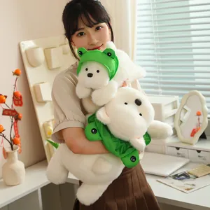 Young woman holding two cute Westie plushies with green frog hats in a cozy room.