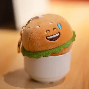 Adorable llavero de peluche con forma de hamburguesa sonriente para mochilas y bolsos