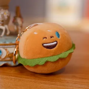 Lindo llavero de peluche de hamburguesa con detalle de lechuga verde y cara feliz