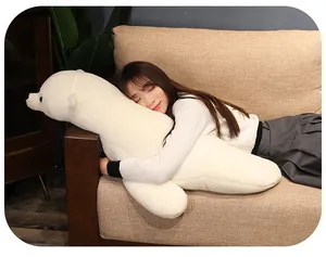 Young woman hugging a large white polar bear plush pillow on a sofa in a cozy home.