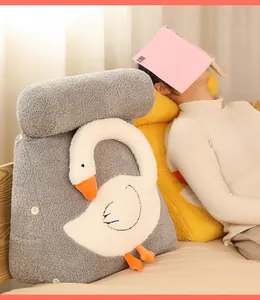 Close-up detail of grey cartoon goose plush wedge pillow shown in a cozy bedroom setting