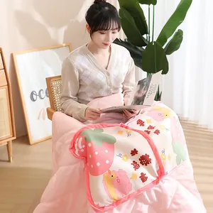 Cute strawberry print 2-in-1 pillow quilt held by a model in a cozy home setting.