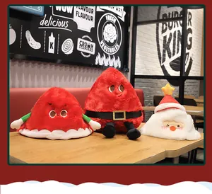 Detailed view of festive red and white plush Christmas dolls and hats on a table