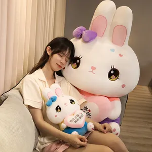 Close-up of cute rabbit plush toy held by a model on sofa