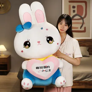 Detailed view of a giant white rabbit plush toy with heart embroidery and blue bow detail