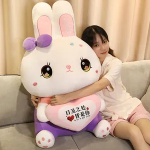 Detailed view of a large white plush rabbit doll held by a model on a living room sofa