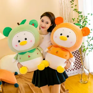 Cute fruit-themed watermelon and orange duck plush toys held by a model in a cozy room