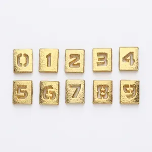 Detailed macro view of 8mm golden frosted alloy hollow number charms 0 to 9 for DIY jewelry craft