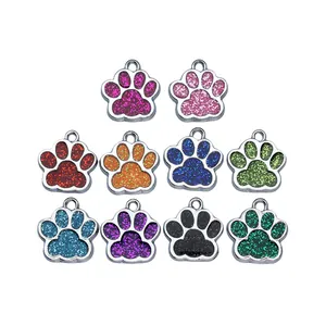 Diverse collection of colorful glitter paw-shaped pet ID tags for custom DIY jewelry
