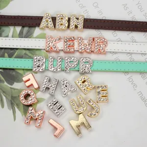 Close-up detail of 8mm rhinestone letter sliders on various colorful DIY leather wristbands