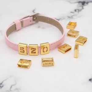 Matte gold 8mm hollow alloy number sliders displayed on a pink DIY faux leather wristband