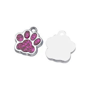 Close-up of pink glittery paw charm and plain silver back for custom engraving