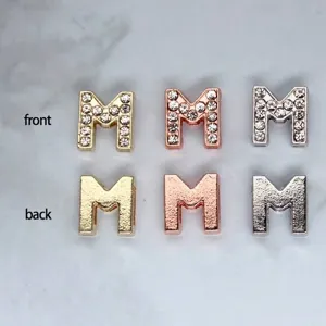 Detailed view of 8mm rhinestone letter M beads in three colors with frosted back finish