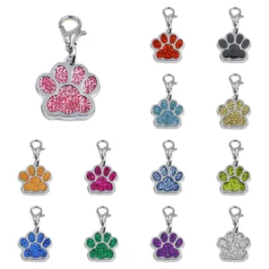 Colorful glitter paw-shaped pet ID tags shown in various vibrant sparkling finishes