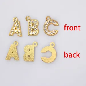 Detailed view of 15mm gold alloy letter pendants showing front rhinestones and back
