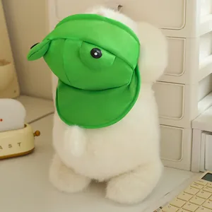Detailed view of soft white plush dog toy wearing a cute green frog visor hat ornament